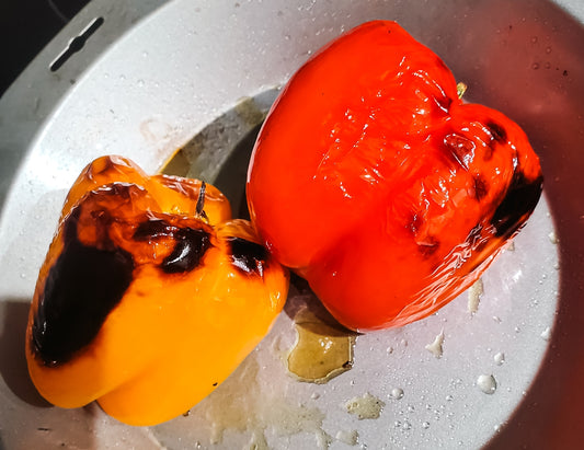 Roasted bell peppers in a pan.
